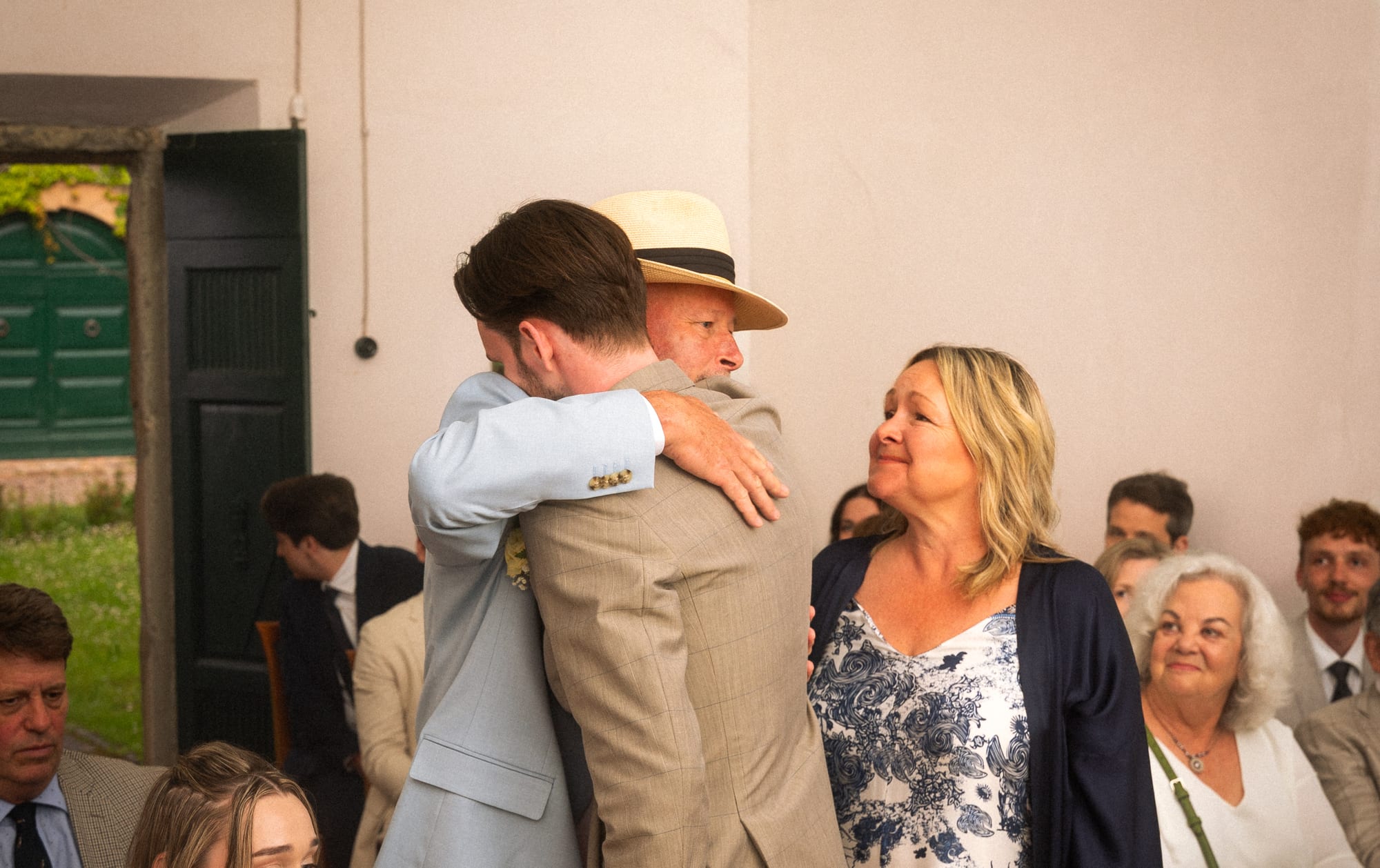 A warm embrace in a receiving line after a wedding ceremony