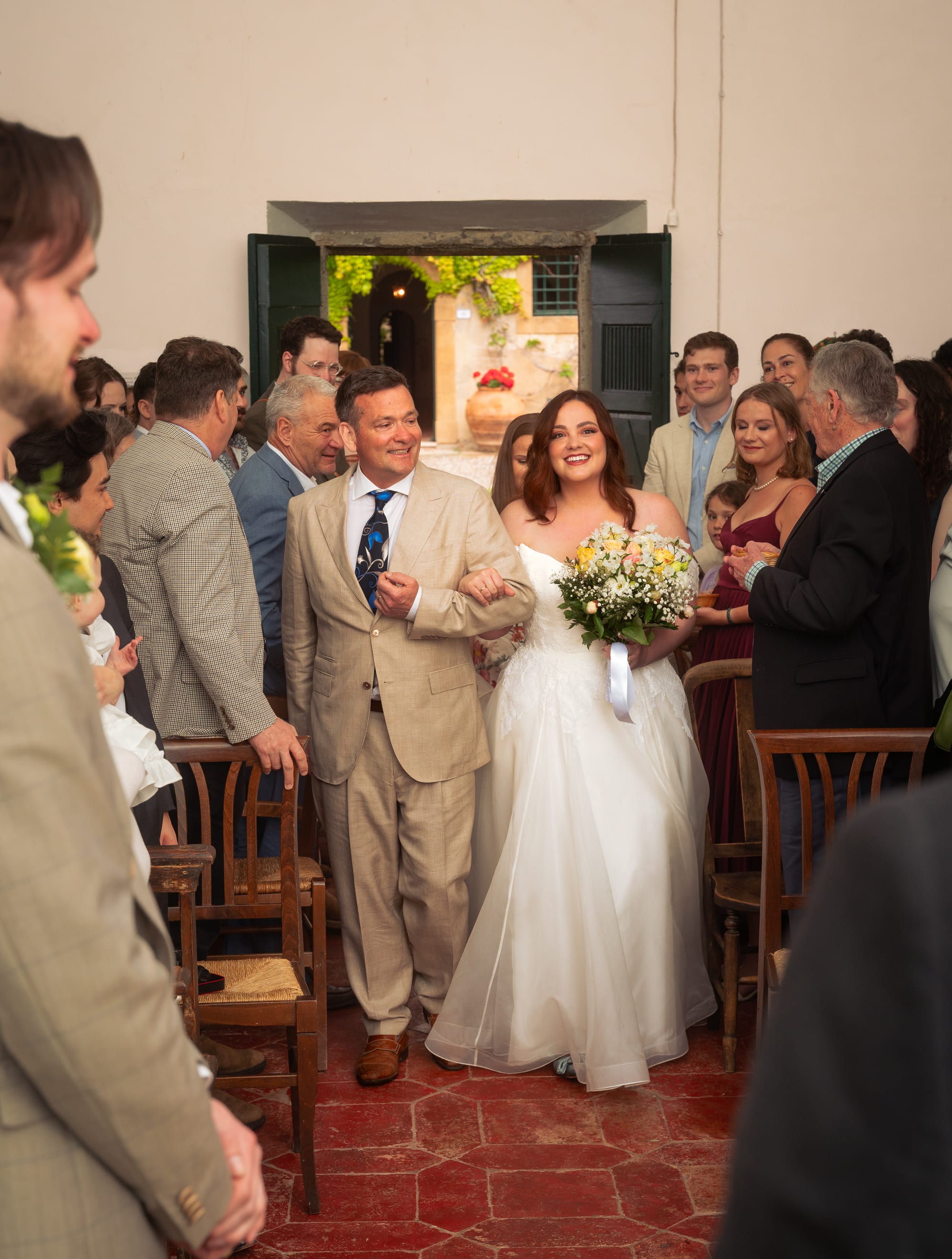 The couple framed against the warm walls of the villa